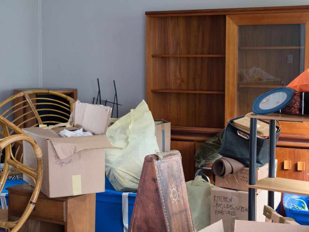 A cluttered room filled with various boxes and furniture